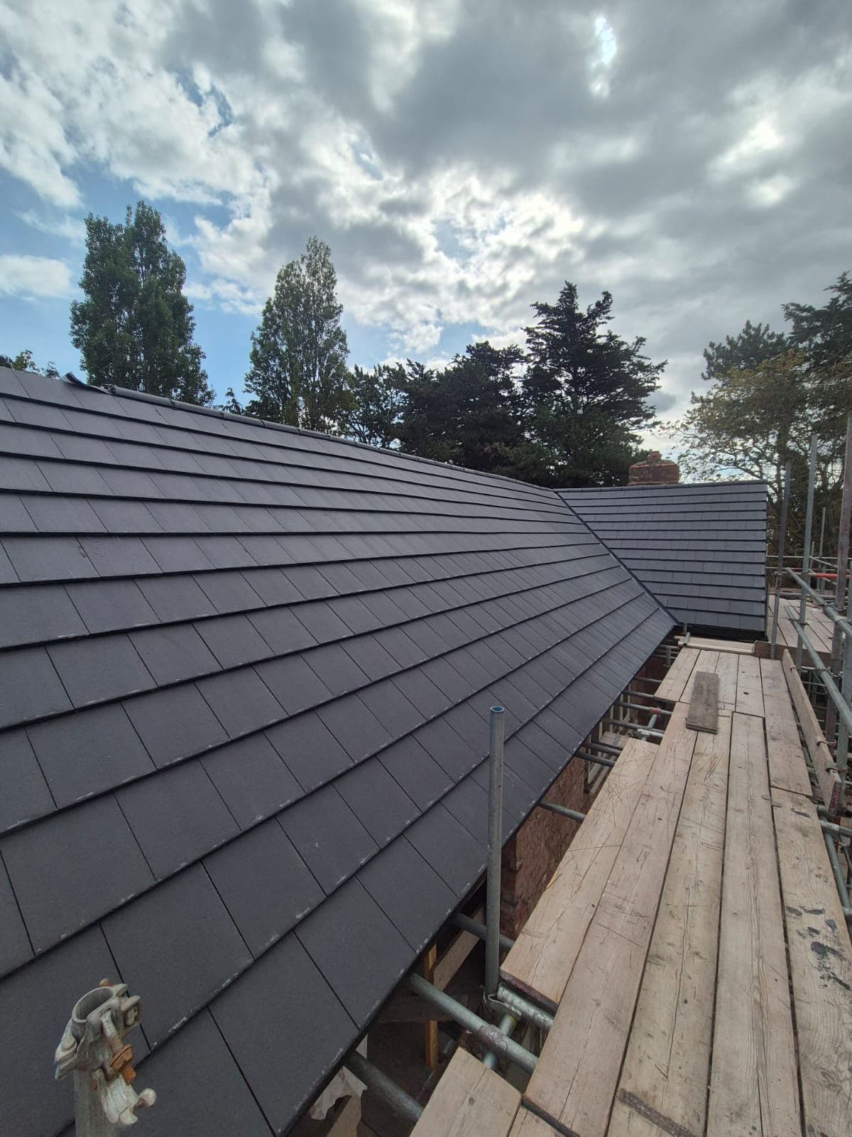 Long eaves run along the new roof covering