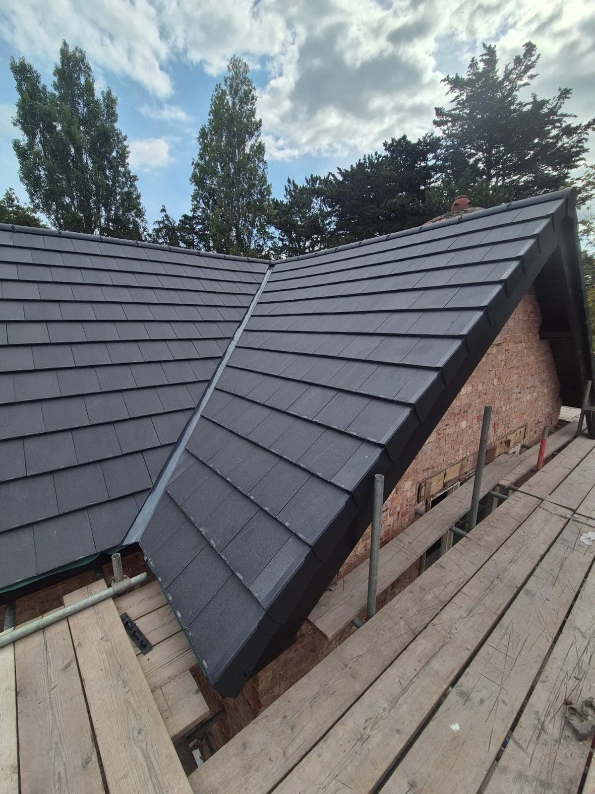 Wide roofscape of the completed re-roof in Lower Heswall