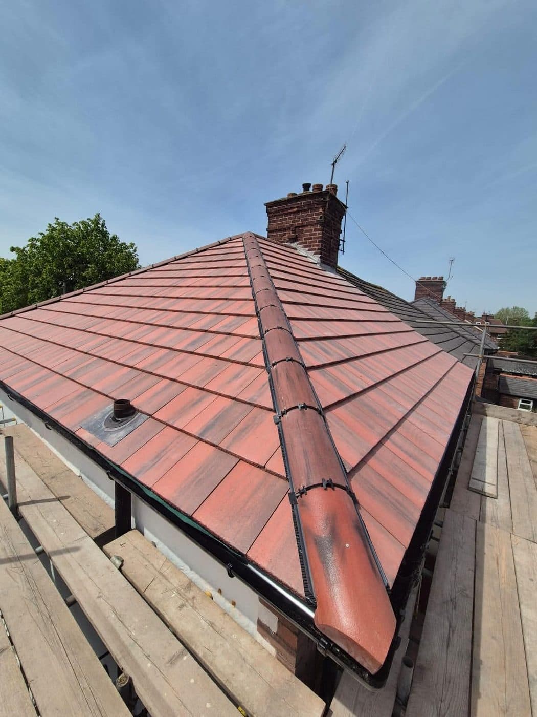 New black uPVC guttering fitted along a re-roofed property, Prenton